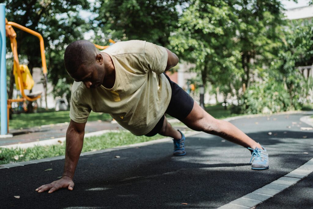 Beginner performing push-ups during a calisthenics workout plan to build strength and endurance.